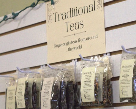 Display of traditional teas with packaging and a sign indicating 'Traditional Teas' on a wall.